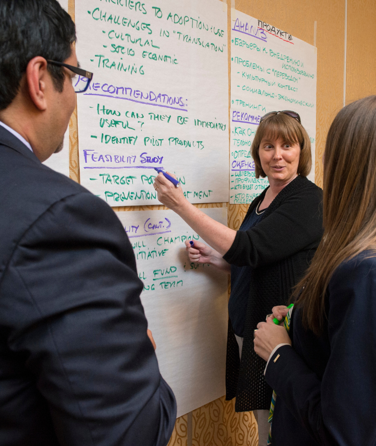 Woman at a chalkboard